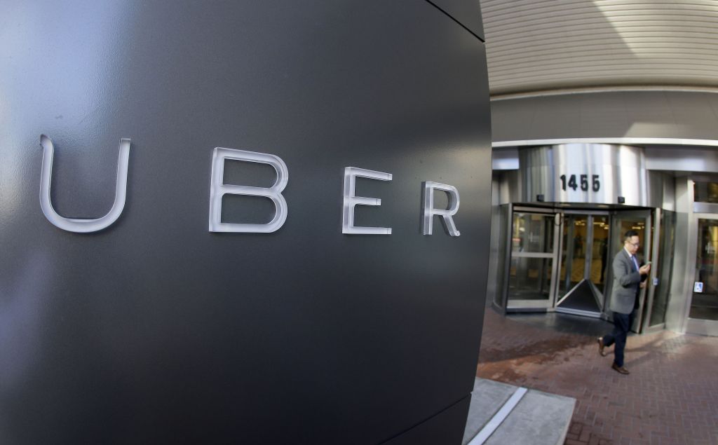 FILE - In this Dec. 16, 2014, file photo a man leaves the headquarters of Uber in San Francisco. Judges for the Pennsylvania agency that regulates buses and taxis recommended on Tuesday, Nov. 17, 2015, a record $50 million fine against ride-sharing company Uber for operating in the state without approval. (AP Photo/Eric Risberg, File) ORG XMIT: NY119