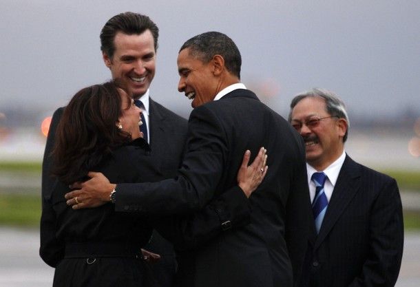 U.S. President Barack Obama is greeted by California Attorney General Kamala Harris (L), California Lieutenant Governor Gavin Newsom (2nd L) and San Francisco Mayor Edwin Lee (R) upon his arrival in San Francisco February 17, 2011. Obama is visiting nearby Woodside to meet with business leaders in technology and innovation, including Apple Inc Chief Executive Steve Jobs, at a private residence.  REUTERS/Kevin Lamarque (UNITED STATES - Tags: POLITICS)