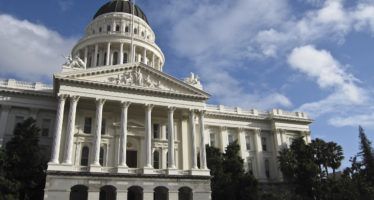 California faces revenue surplus, persistent debt